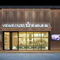 Modern Storefront Facade Design Featuring Wooden Slat Glass Doors Illuminated Signboard And Interior