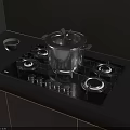 Kitchen Cookware Setup With Stainless Steel Pot On Black Gas Stove And Wooden Cabinets