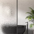 Elegant Bathroom Glass Partition With Textured Surface Black Bathtub And Green Plant
