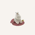 White Plush Toy with Round Nose Yellow Eyes Sitting on Red and White Striped Cushion