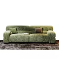 Green Upholstered Sectional Sofa with Two Colored Pillows on Brown Rug and Books on Seat