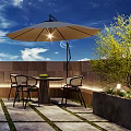 Outdoor Terrace With Brick Building Glass Doors Table Chairs Umbrella Plants And Lighting