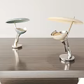 Two Stylish Modern Table Lamps with Metal Bases and Colored Shades on Wooden Table