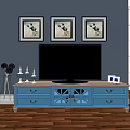 Blue TV Stand with Drawers Glass Doors TV and Decorations on Gray Wall Wooden Floor