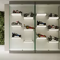 Display Cabinet With Glass Door And Model Motorcycles Cars On Shelves By Green Plant Wall