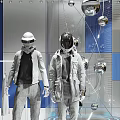 Fashion Models In Futuristic Space Themed Store With Metallic Outfits And Orb Decorations