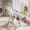 Silver Foldable Metal Clothes Drying Rack With Hanging Clothes Near Window In Laundry Room