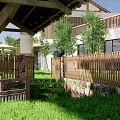 Traditional Japanese Courtyard Entrance With Thatched Gateway Stone Wall Flower Box And Blossoming Trees