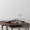 Artistic Carved Sculpture Display On Wooden Table With Magazine And Glass