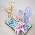 Handcrafted Decorative Sculpture With Golden Geometric Structure And Colorful Paper Flowers On Black Striped Tray
