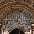 Romanesque Entrance Gate With Red Brick Structure Carved Archway Stone Columns And Wooden Doors