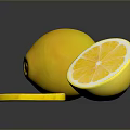 Fresh Ripe Whole Lemon and Sliced Lemon with Juicy Pulp on Dark Surface