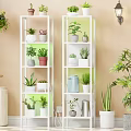 White Multi Tiered Shelving Unit With Various Potted Plants For Indoor Decoration