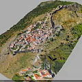 Natural Mountain Village Landscape With Red Roofs Lush Greenery And Hilly Terrain