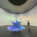 Blue Water Splash Shaped Art Installation With Visitor Interacting In Modern Gallery Space