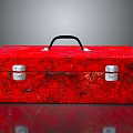 Red Textured Toolbox With Black Handle And Silver Latches On Shiny Surface
