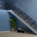 Ornate Staircase With Black Iron Railings Blue Wall Green Plant Black Vases And Pebble Decor