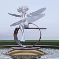 Silver Fairy Sculpture With Wings On Circular Golden Striped Base By Pond