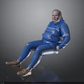 Woman in blue jumpsuit with white text sitting on black surface smiling in brown shoes
