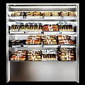 Retail Display Shelf With Organized Packaged Food Products On Multiple Layers