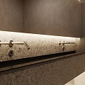 Modern Sleek Bathroom Faucet On Terrazzo Countertop With Gray Walls And Lighting