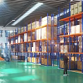 Efficient Industrial Warehouse With Metal Racking Cartons Worker Forklift And Green Floor