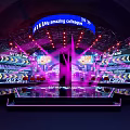 Dynamic Stage Design Featuring Purple Lighting LED Screens And Blue Amazing Collage Banner