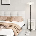 Double Bed with Gray Tufted Headboard Brown Pillows Cozy Blanket Floor Lamp and Matisse Print