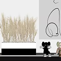 Golden Wheat Ears in White Container with White Pebbles Beside Black Decorative Lines and Sculpture