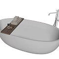 Modern White Oval Bathtub with Water Tray Folded Towels Toiletries and Shower Fixture