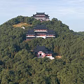 Ancient Chinese Architecture On Mountain Slope With Lush Green Trees And Traditional Rooftops