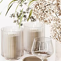Elegant Tableware Set with Marble Vase White Flowers Green Foliage Wine Glasses Candles and Trays