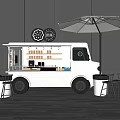 White Food Truck Outdoor Setup With Black Tables Chairs And Umbrella