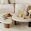 Modern Asymmetrical Coffee Table with Books Fruit Bowl Vase and Candles in Living Room