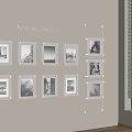 Paintings Display With Framed Black And White Photos On Beige Wall Near Window Blinds