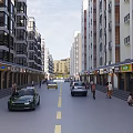 Commercial Street With Multi Story Buildings Ground Floor Shops Store Signs Pedestrians And Vehicles