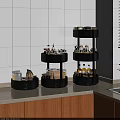 Three Tier Black Rotating Storage Racks On Kitchen Countertop For Organizing Spice Jars And Bottles