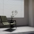 Green Leisure Chair with Small Potted Plant by Window Blinds White Wall and Decorative Shelf