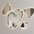 Irregular Shaped Wall Mirrors With LED Lights Reflecting Sofa And Plants In Modern Living Room