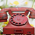 Red Vintage Rotary Phone With White And Yellow Daisy Flowers Background