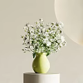 White Small Flowers in Light Green Vase on White Cylindrical Pedestal with Light Background
