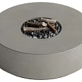 Modern Round Concrete Fire Pit With Wood Logs And Black Stones