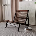 Elegant Leisure Chair With Wooden Frame Woven Design On Striped Rug Near Stack Of Books