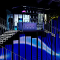 VOGUE Modern Exhibition Space With Illuminated Staircase And Blue Lighting Interior