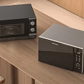 Sleek Modern Black Kitchen Microwave And Oven Appliances On Wooden Countertop
