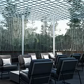 Outdoor Pergola With Grid Roof Structure Wooden Deck And Tables Chairs Surrounded By Green Plants