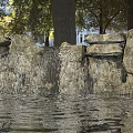 Garden Ornament Natural Stone Waterfall Design with Flowing Water and Lush Trees in Background