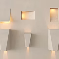 White Wall Lamps With Various Geometric Shapes On Light Colored Wall And Lighting Effects