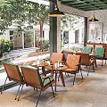 Cozy Cafe Interior With Wooden Chairs Green Cushions And Garden View