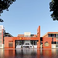 Red Brick School Building With Modern Main Entrance And Water Reflection Surrounding Trees